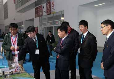 Group photo of reviewing experts on booth of CNPC Drilling Research Institute Exhibition