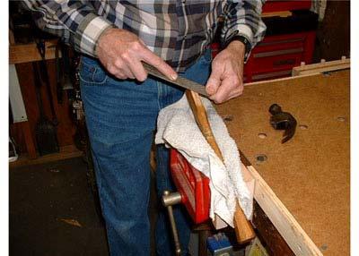 File from the end of the handle down about an inch, several strokes with the coarse flat side of the rasp.