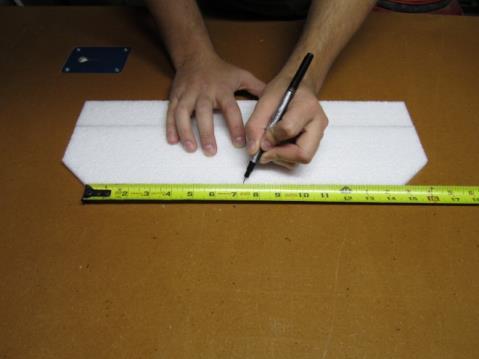 105. Put hot glue on the recessed surface of the fuselage and place the horizontal tail piece in place.