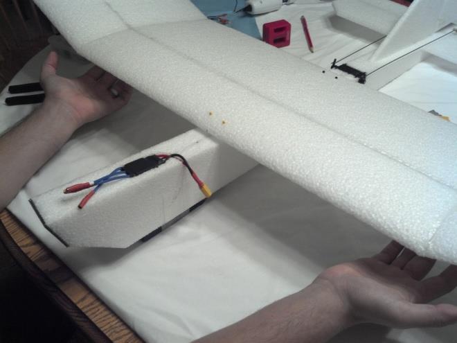 144. Make sure the Velcro s ends match up properly, and trim off any excess Velcro. 145. Use your hot glue gun to glue down the Velcro where it lays over the opposite side and top of the fuselage.