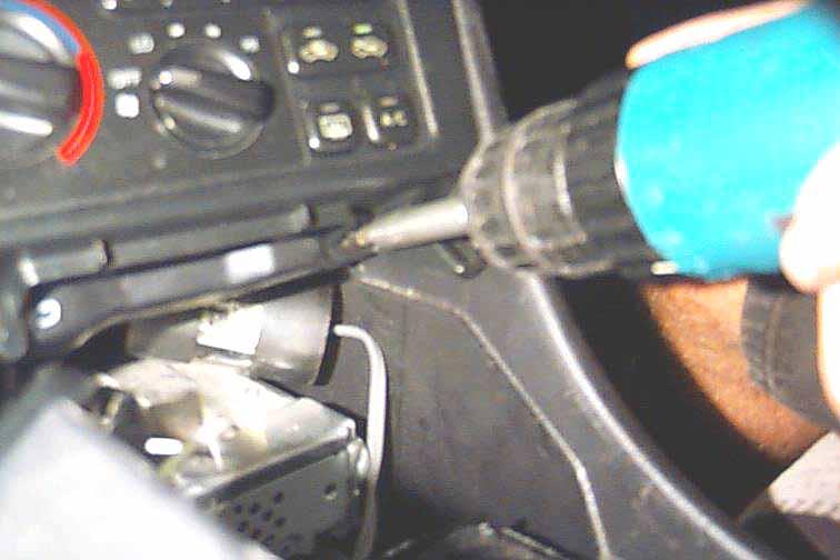 Factory Radio STEP 1: nsert the tip of a small flat head screwdriver between the plastic dash panel surrounding the gear shift area and the body of the center dash.