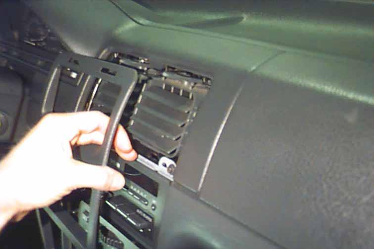 Gently pull the lower part of the plastic dash panel until it begins to unsnap from the main dash assembly.