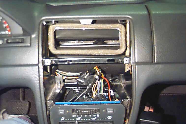 Unplug the black cable from the rear of the radio. Unplug the plastic connector from the rear of the radio.