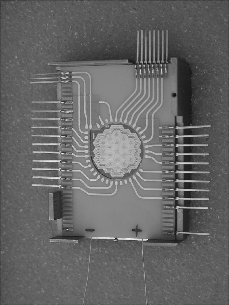 Fig. 5. 10 channel preamplifier and five of two channel shaper hybrid boards on a carrier printed circuit board for analog readout of 10 cells of SDD. Fig. 4.