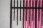 Illustration 4.14 shows that the magenta lines are part of the image printed on the resolution strip. The magenta lines are thinner than 0.25mm, and are estimated as 0.1mm.