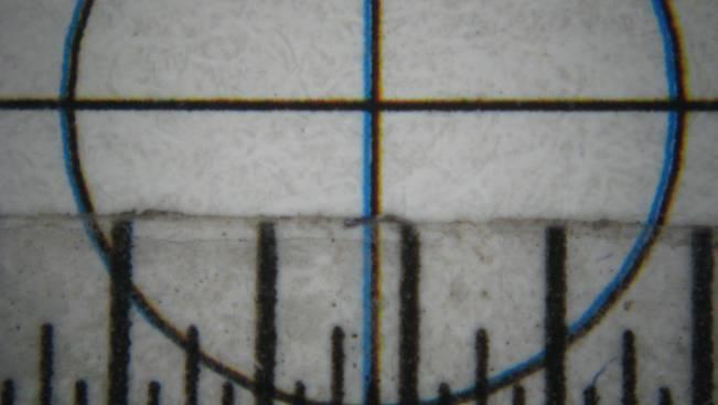 Also by using the standard magnifier that the Printing and Research Center uses to observe the vertical lines of the overlayed crosshair, we know that the difference between the blue overlay and