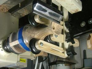 To add some support, cut four strips ½ x 3 (¼ thick or less). Using hot glue attach these at intervals to the shoulder of the tenon mounted in the chuck.