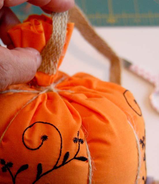 The smaller pumpkin is wrapped once, aiming for a height of no less than 1 but no more than 1-1/2 which allows extra fabric to extend beyond the top of the stem s roping.