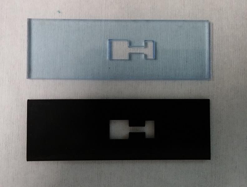 a 7 mm 7 mm b Figure 14 (a): Laser cut sputtering masks made from 1/8 ABS and ¼ acrylic. (b) Pyrex slide with a Cr then Au layer deposited as an electrode.