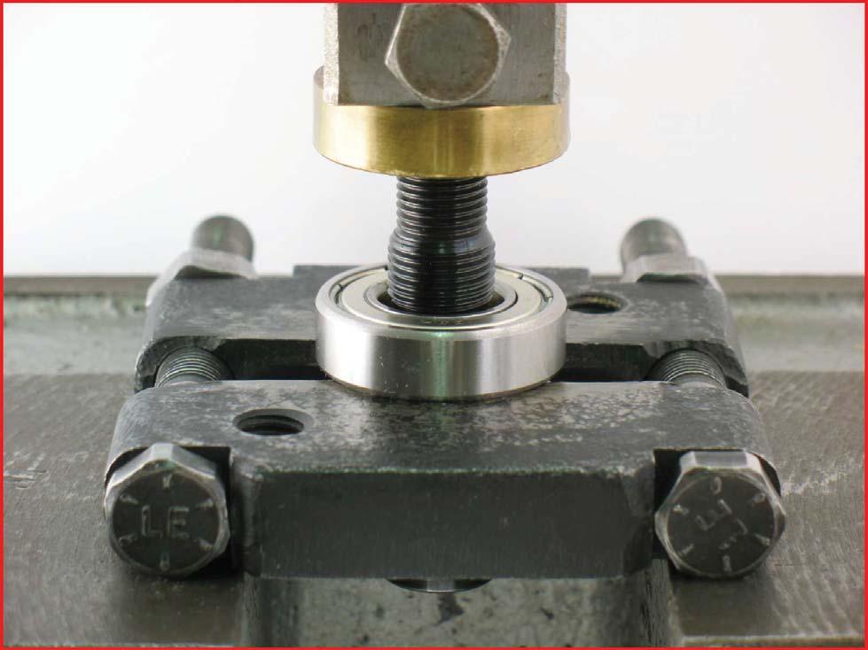 8. Use the arbor press to push the