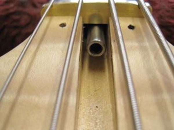 Turning the nut counter-clockwise will loosen the Truss Rod and allow the tension of the strings to increase relief / bow in the neck and serve to move the strings further away from the fingerboard.