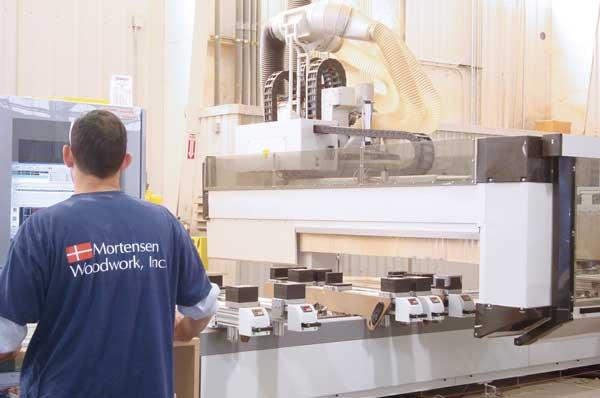 The Busellato five-axis CNC machining center has pods for horizontal and edge machining of panels. Veneer and solid wood constitute 80 percent of Mortensen Woodwork s projects.