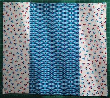 As shown, sew the two contrast strips to either side of the centre outer fabric panel.