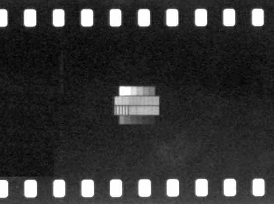 It can fit into an 18 mm diameter circle or into a standard 35 mm motion picture frame. The gray scale is shown in the outer rows and the sinusoidal areas in the middle two rows.