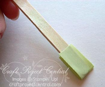 Step 7 Apply SNAIL adhesive to the end of a Popsicle stick (on both sides) and