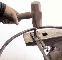 Use a heavy hammer to upset the tenon in the hole for several blows. Be careful to upset bolt. The bolt head must be low or it will be higher than the tenon heads.
