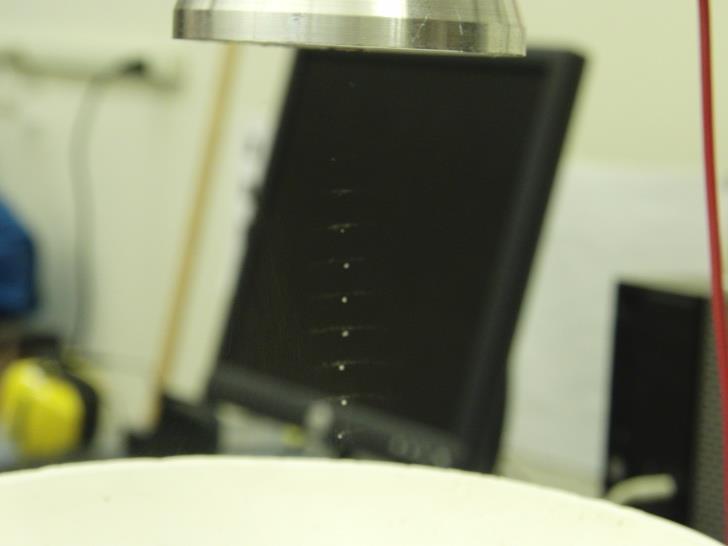 Figure 9: Levitation of water droplets at half of a wavelength apart. At 30V, we waved a small piece of paper between the ultrasonic transducer and the reflector.