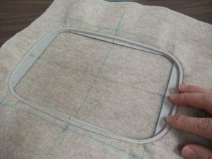Spray a piece of medium weight stabilizer with temporary adhesive and smooth the fabric on top.
