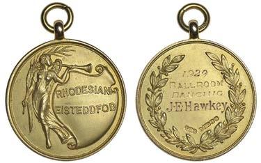 MEDALS OF SOUTHERN AFRICA 2260 Rhodesian Eisteddfod, a gold award medal by Turner & Simpson, winged female figure with palm branch and trumpet, rev. wreath, named (1929 Ballroom Dancing, J.E. Hawkey), hallmarked Birmingham 1928, 28mm, 11.