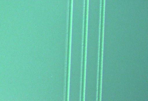 Grooves made in borosilicate glass by slit imaging. Laser parameters: 193 nm, 1.1 J/cm², 2 pulses (a), (b) scanning electron microscope images; (c) optical microscope image Fig.