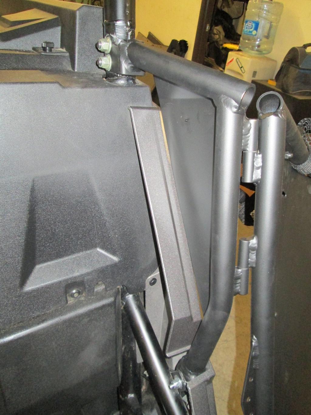 REAR DOOR INSTALLATION: Upper Mount It is usually easier to do one side at a time to keep the cage from moving with too many bolts loose Slide the top door mounting bracket over the cage use the