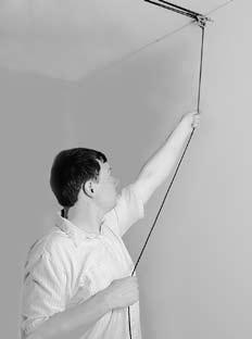 Lower TOP Securely grip rope, apply tension and angle it away from front wall. Bring arm up to let rope out and then back towards the wall to lock the rope. Repeat until top is at desired height.