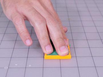 Use your thumb to help press the doh into all of the corners.