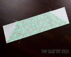 Sew a scant quarter inch seam on each side of the line. Cut apart and press open. Square up both HSTs to 3 (there will not be much to trim off, you are just making sure the block is square).