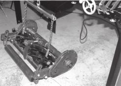 LIFTING REEL INTO POSITION WHEN USING THE "V" MOUNTING BRACKETS Position the reel behind the grinder on the floor so the front of the mower faces towards the front of the machine.