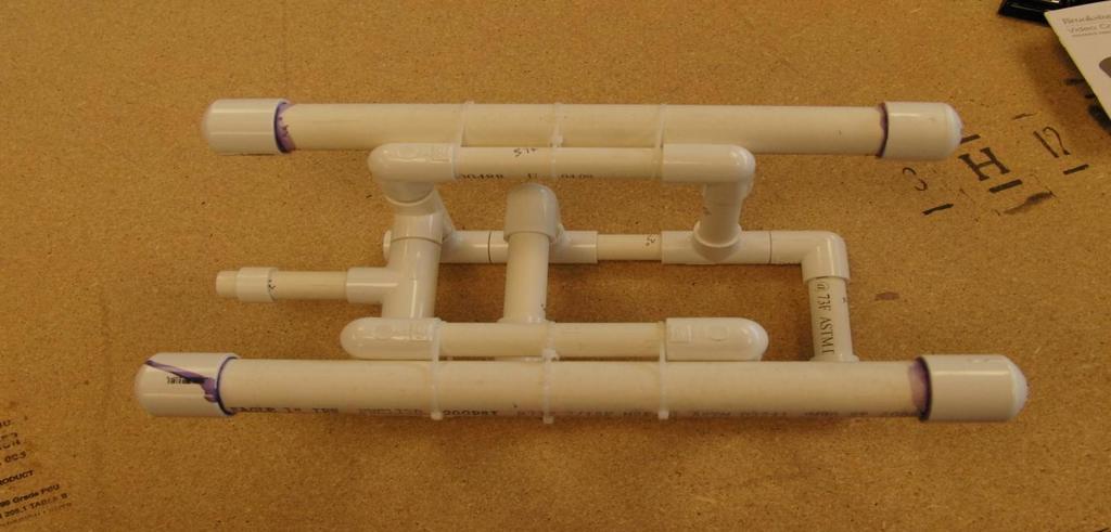Remove any excess glue from the outside of the pipe using a paper towel; discard the towel. 4. Repeat step 3 for the other end of the pipe, and then for each end of the other pipe, one end at a time.