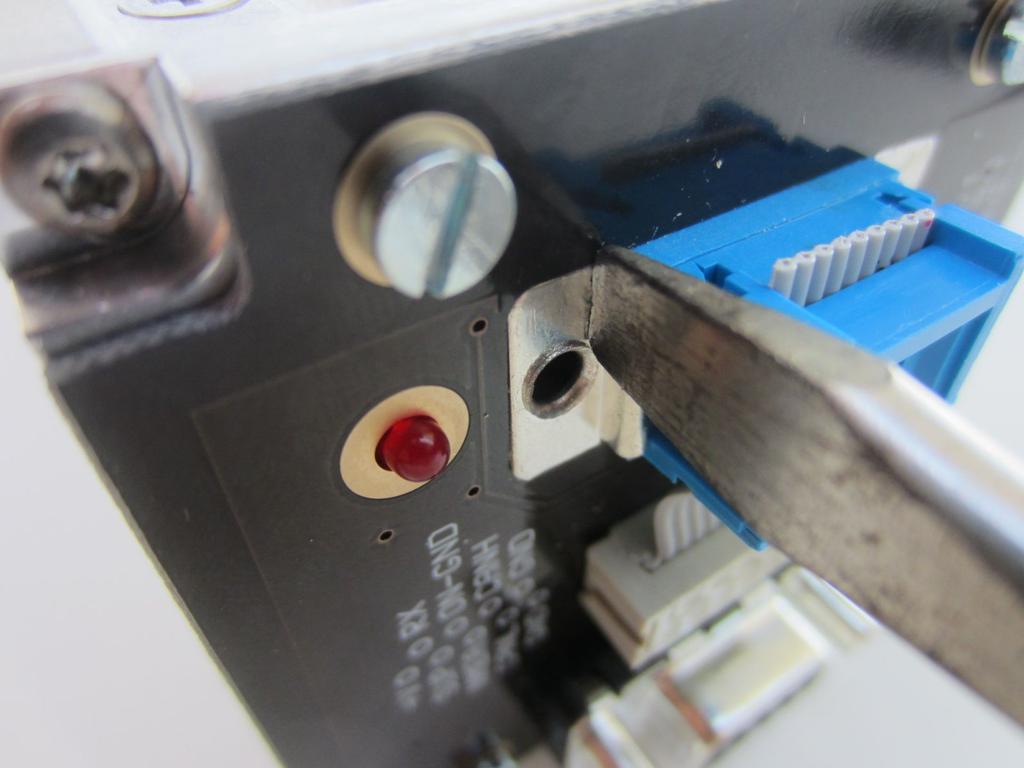 Using a screw driver or suitable object, carefully press-fit the blue connector into the PCB slot.