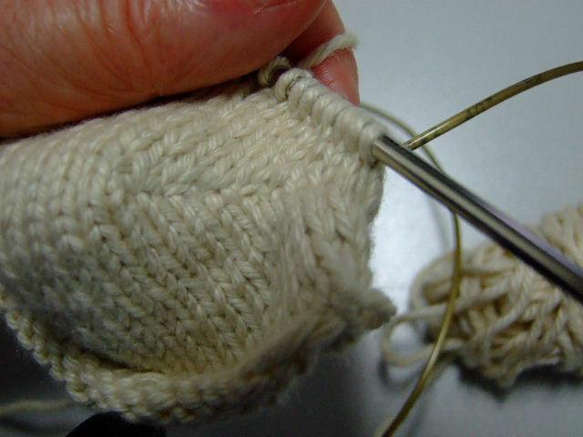 After knitting one more complete round, slip the extra stitches on each end back to their