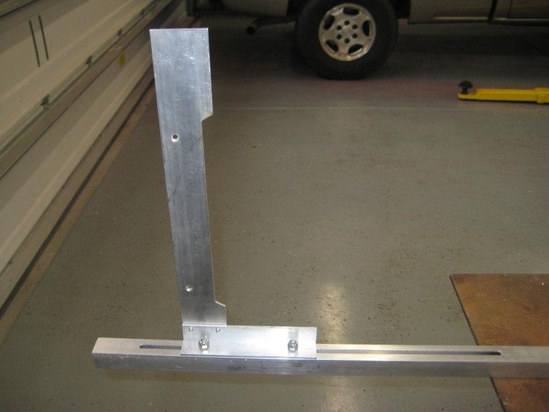The arm is 15 inches long and is made from 2 inch wide aluminum strip. I cut a section from the center so the arm would clear a tire bulge.