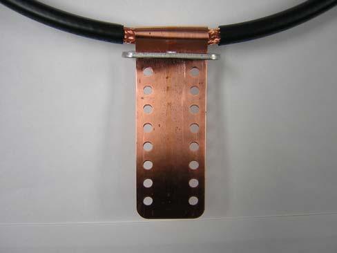 Slip the perforated strap through the slotted bracket as shown in Figure 7. Note the orientation of the bracket.