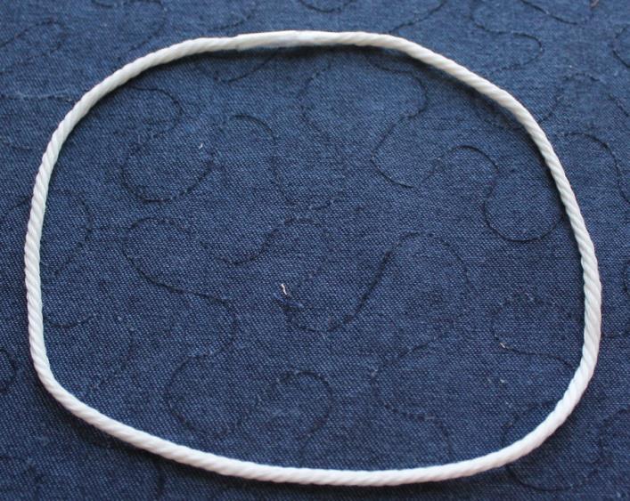 10. Tape the ends of the cord together to complete a circle. Overlap them just barely. 11.