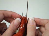 . Starting from the end of your turned heel, use another new needle to pick up and k stitches along the side of the heel flap, continuing the -stitch MC, -stitch CC pattern you already have in the