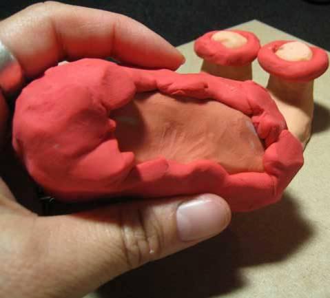pushed on for buttons. A clay tool was used to make the indentations for the eyes and mouth.