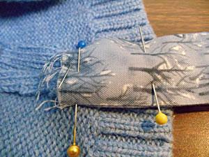 Fold the piece into a loop and pin it to the inside seam of the sweater stocking (the one toward the