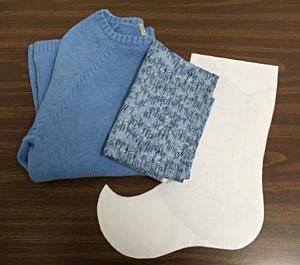 Supplies Needed: **An old sweater - this one is cotton, but wool and other fabrics are fine choices too **2/3 yard coordinating fabric for lining - we used printed quilter's cotton **Stocking pattern