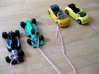 How to go about: Tie the string to your toy car and to a pencil, empty toilet paper