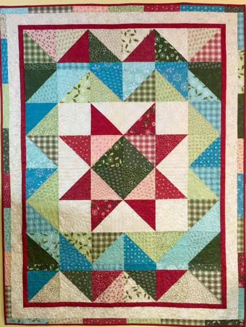 This easy quilt uses one layer cake and 7/8 yard of a dark and