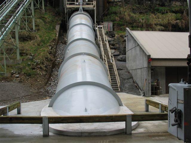 The constructor requested that the strap be made in two pieces with one piece being shop-welded to the bottom of one penstock section and with the other piece of the strap plate shop-welded to the