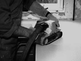 When using a belt sander, hold it flat to the surface and work beyond the seam, continually moving to avoid overheating and gouging.