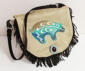 Fringed Handbag A fringed handbag makes a fabulous and stylish accessory, year round! Add your favorite embroidery designs -- there are stitching areas on the purse flap and the front of the bag.