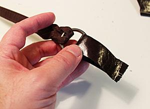 To prepare the handle straps, cut two pieces of leather, faux leather, or vinyl to 3/4" wide by 5" long.