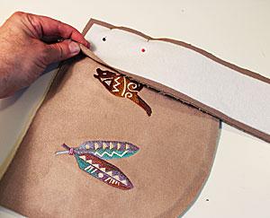Now it is time to assemble the outer shell! Lay the embroidered front piece flat with the right side facing up.