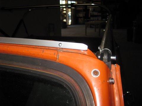 Install the vertical door surround bar using the provided thumb