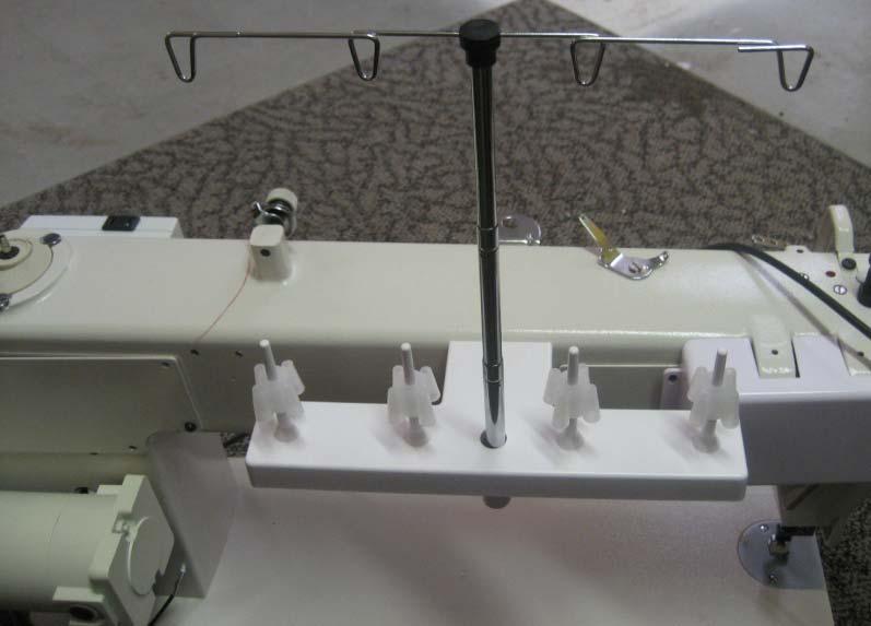 To attach the thread stand on the side of the machine with the motor you will see two screws towards the front