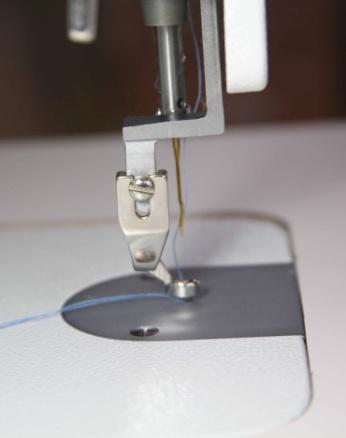 Adjustment screw If you are quilting on batting that is thicker than normal you might need to raise the hopping foot.