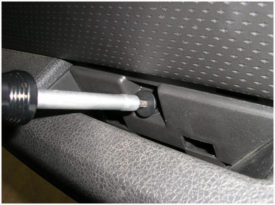 2. Remove the cover from the door pull/armrest area.